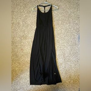 A xs , straight black dress. Has a slit at the bottom and the back is open.new
